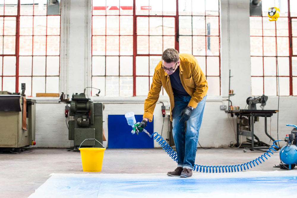 Designer Bill Amberg is spraying paint