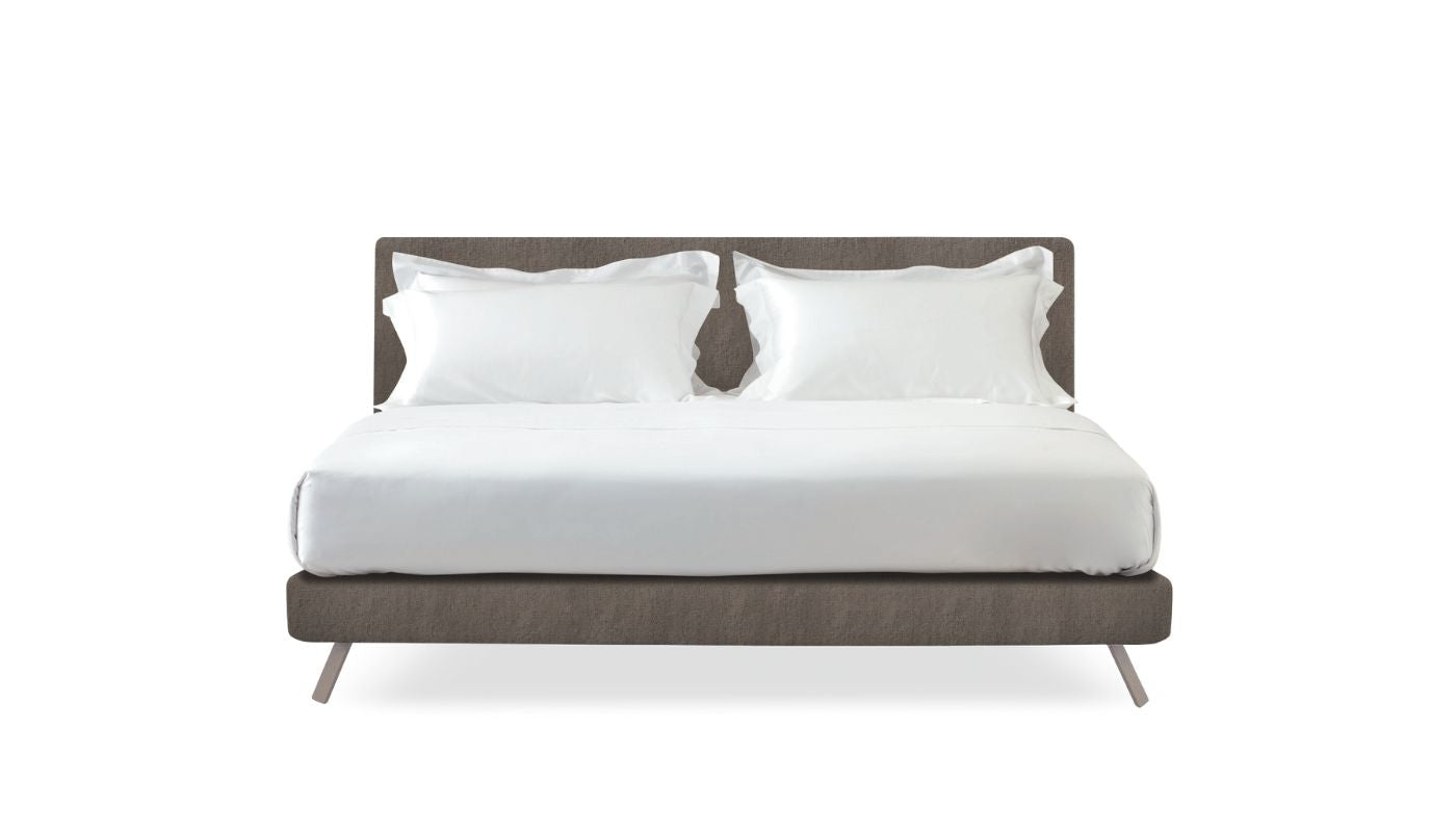 Bed with white bedding and pillows on a white background