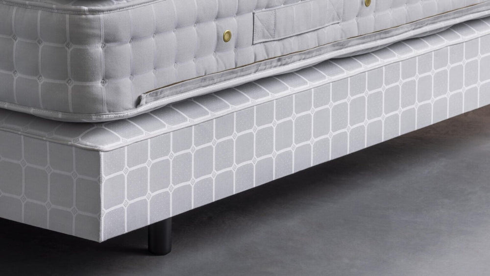 Angle view with details of a Savoir mattress and base