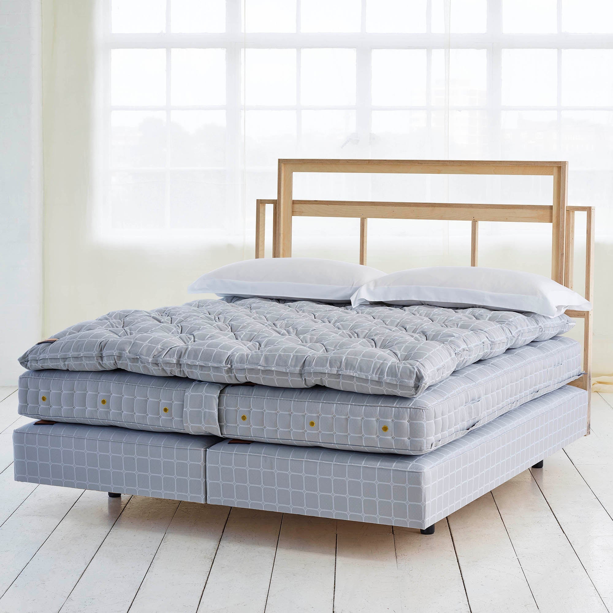 Side view of the No2 Savoir bed set featuring the mattress, the base and the topper