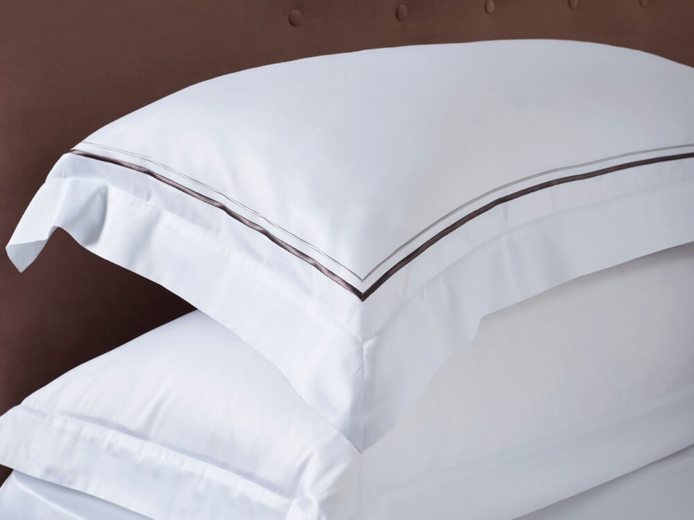 Side view of the Savoir sateen pillowcase with grey cording