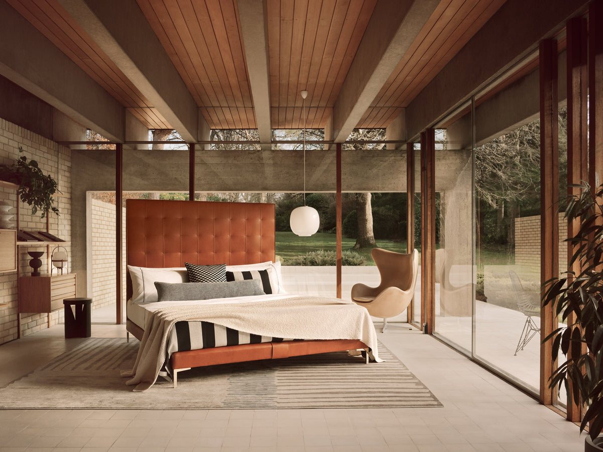 Savoir Winston bed with striped cushions on the bed