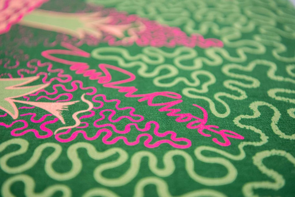 Very close-up of the Zandra Rhode signature on velvet fabric