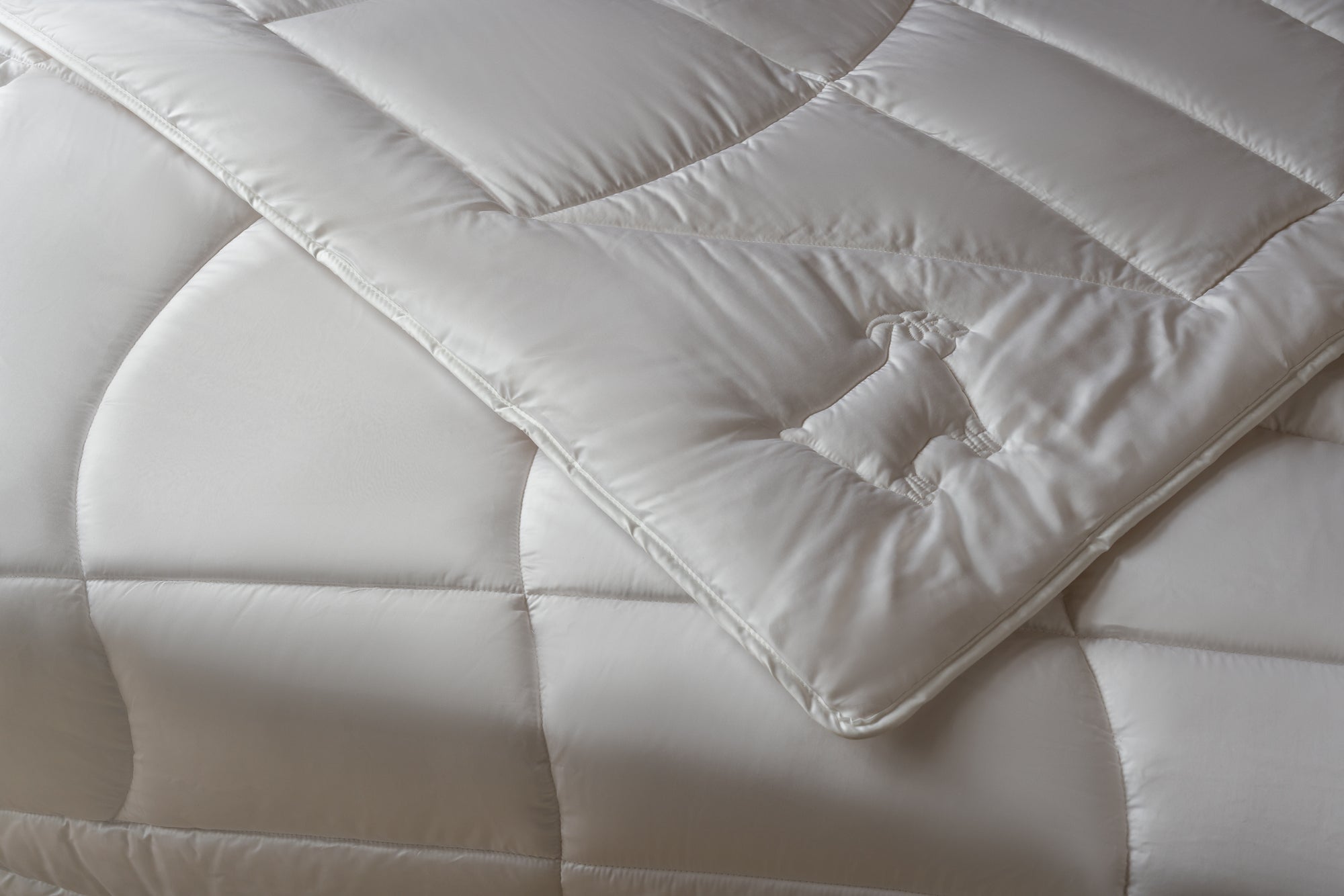 Detail of embroidery on cashmere duvet