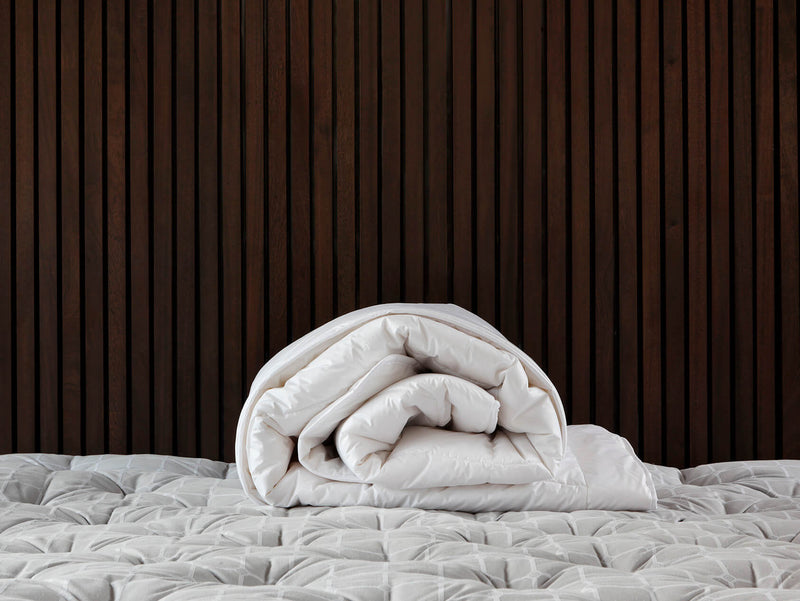 Cashmere duvet rolled up on a savoir topper