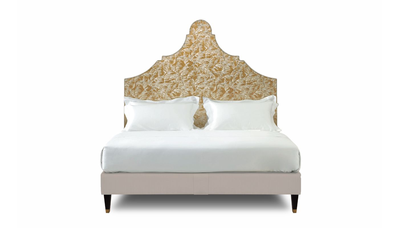 Undressed Claudia bed with an orange blue fabric on headboard and light pink on base, featuring cushions