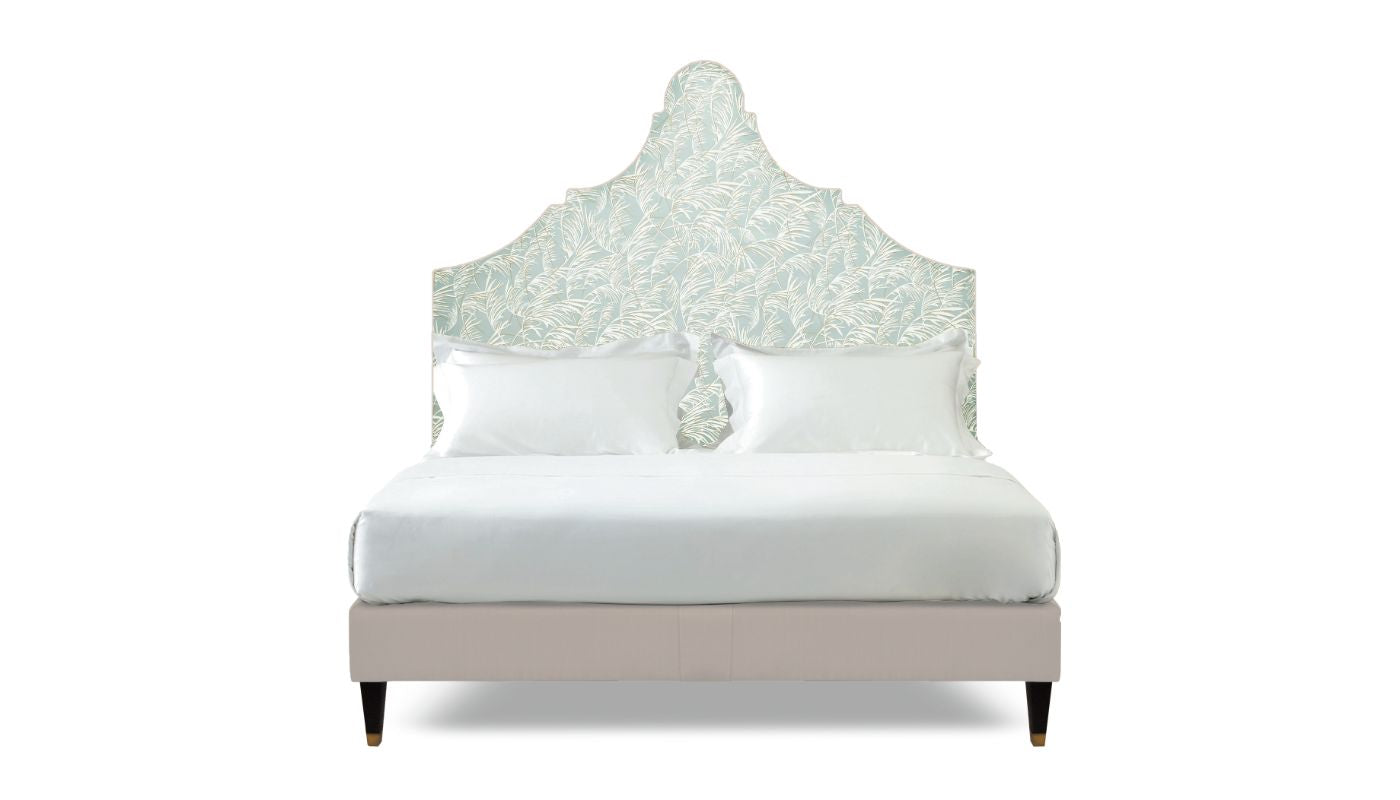 Undressed Claudia bed with a sky blue fabric on headboard and light pink on base, featuring cushions