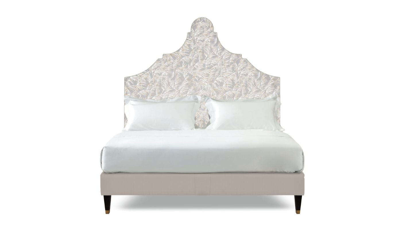 Undressed Claudia bed with navy a white fabric on headboard and light pink on base, featuring cushions