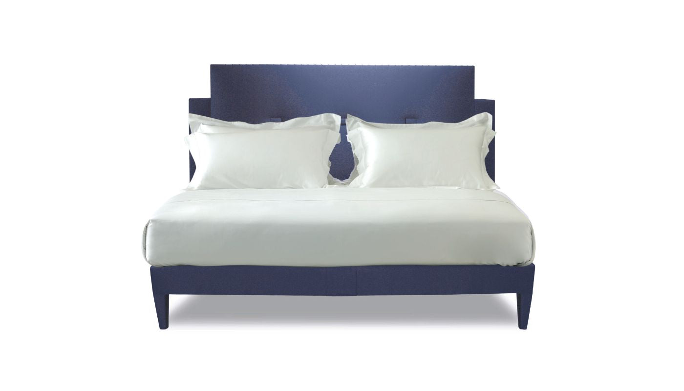 Undressed Savoy bed with a cobalt blue headboard and base featuring a mattress and cushions