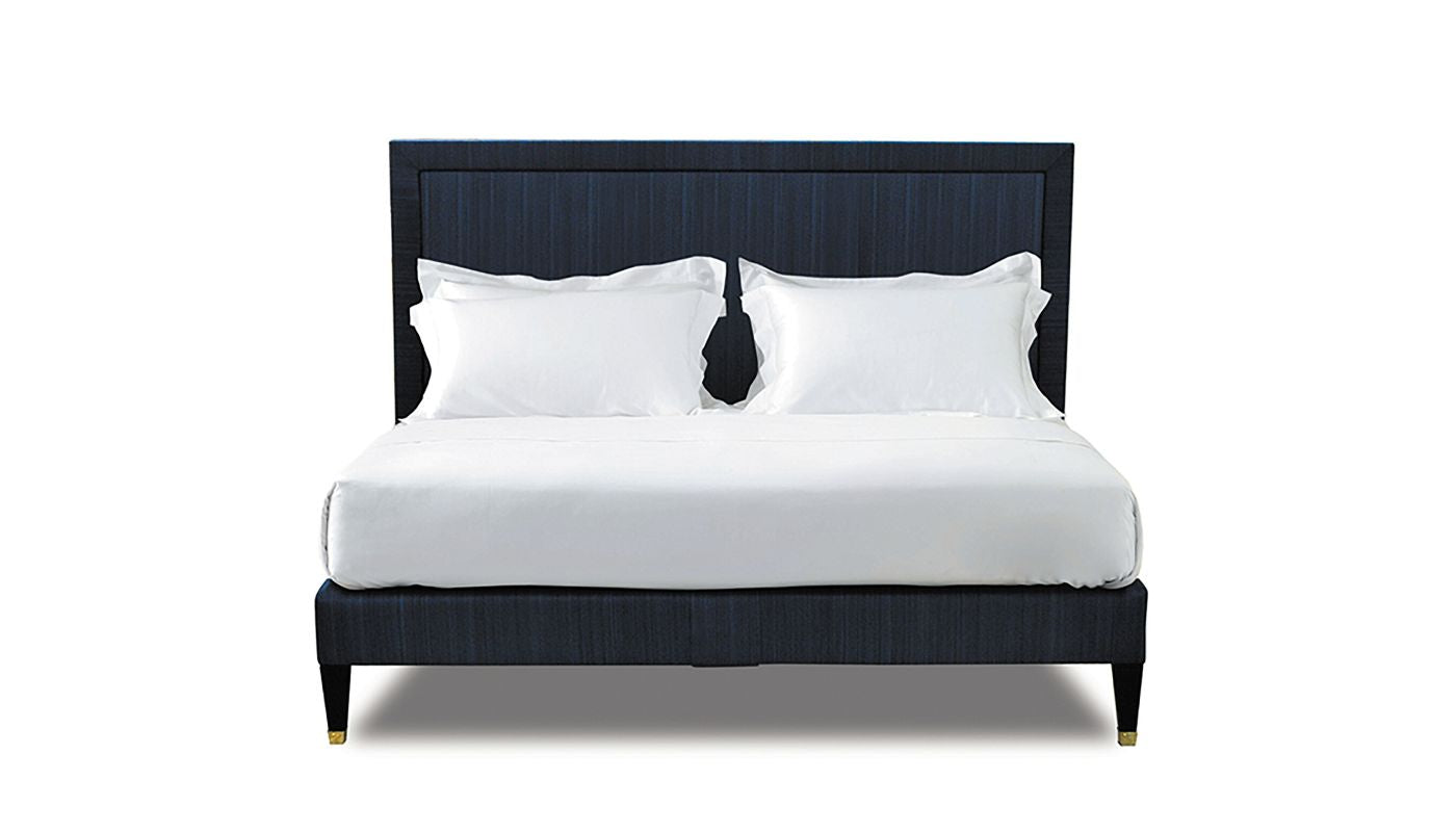 Undressed Virginia bed with a navy blue headboard and base featuring a mattress and cushions