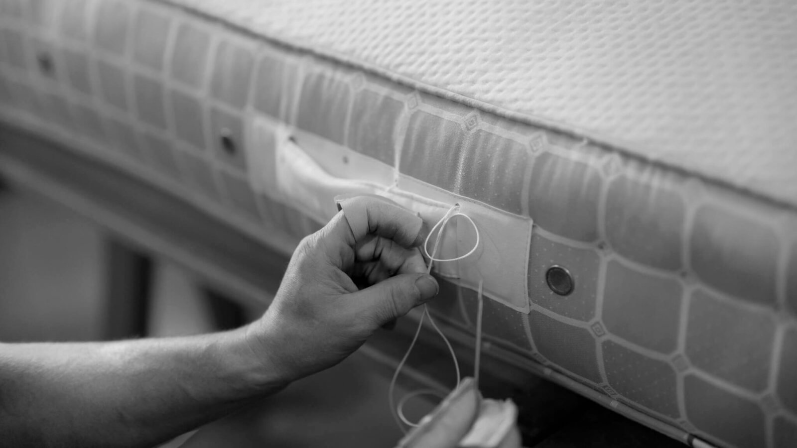 Black and white picture of a Savoir bed mattress in the making