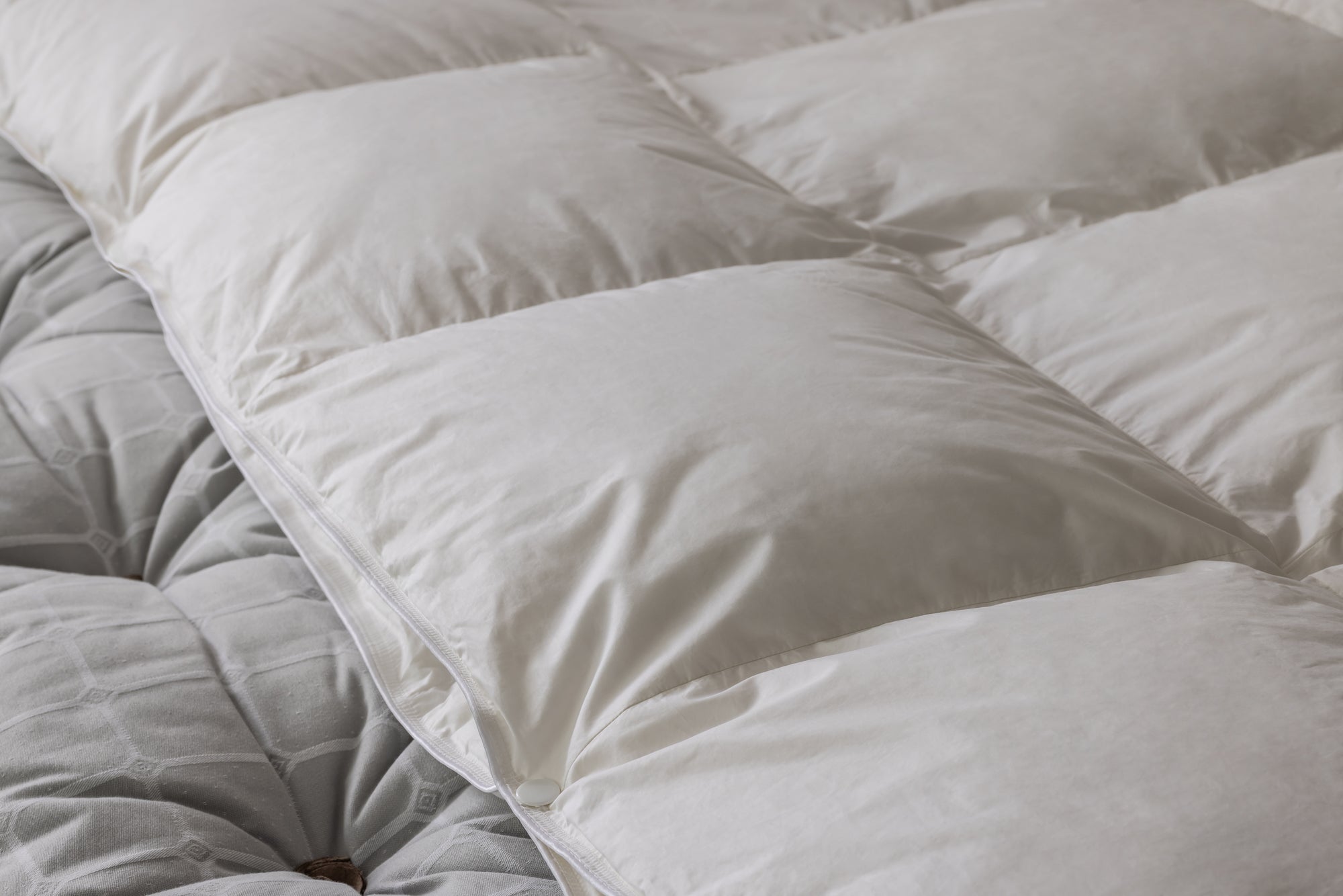 close up of popper on quilted goose down duvet