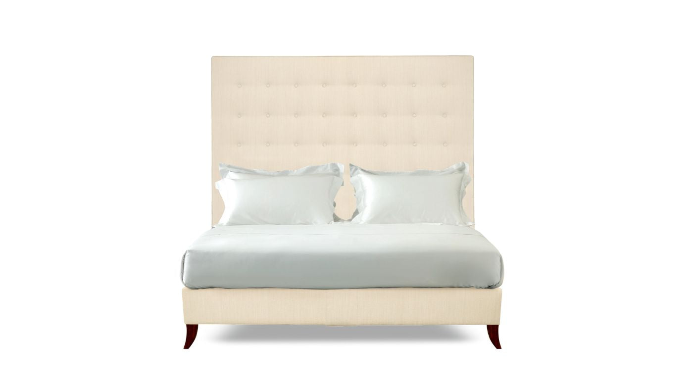 Undressed Holly bed with a cream colour headboard and base featuring a mattress and cushions