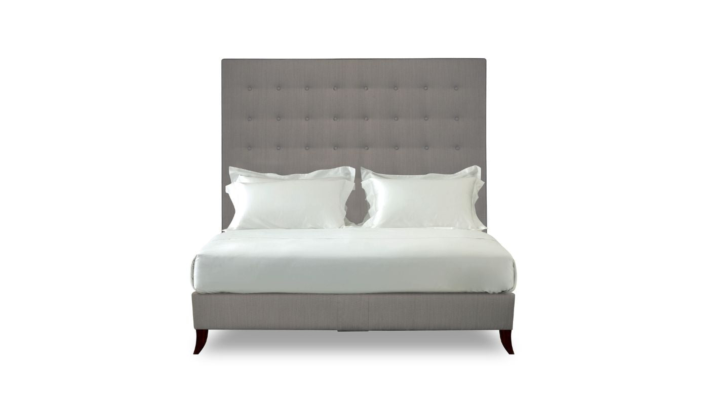 Undressed Holly bed with a dark grey colour headboard and base featuring a mattress and cushions