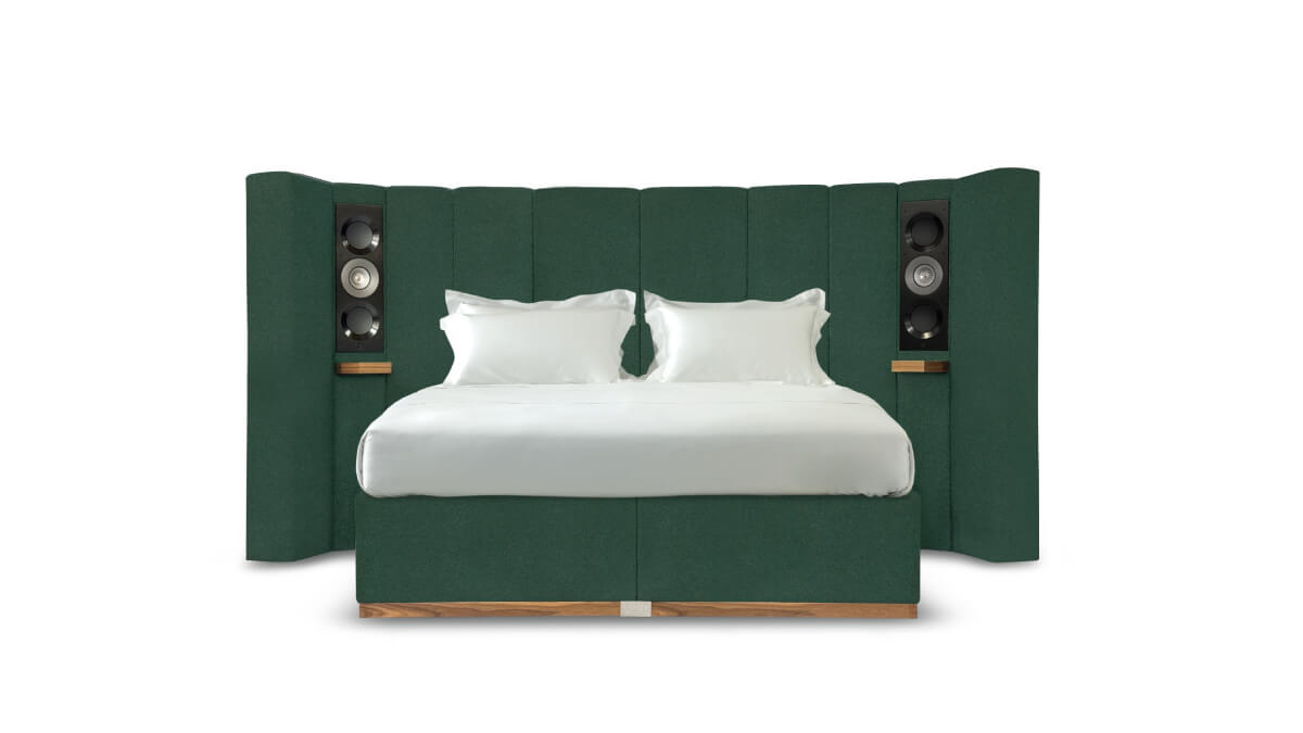 A view of the Seventy Five bed upholstered in textured pine green fabric
