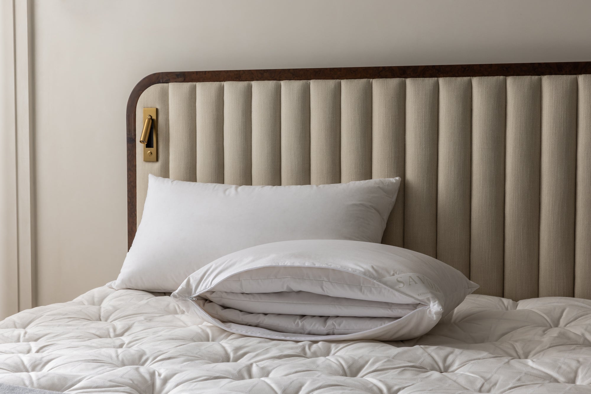 bed with two multi-tension pillows and one unzipped showing 3 inner layers