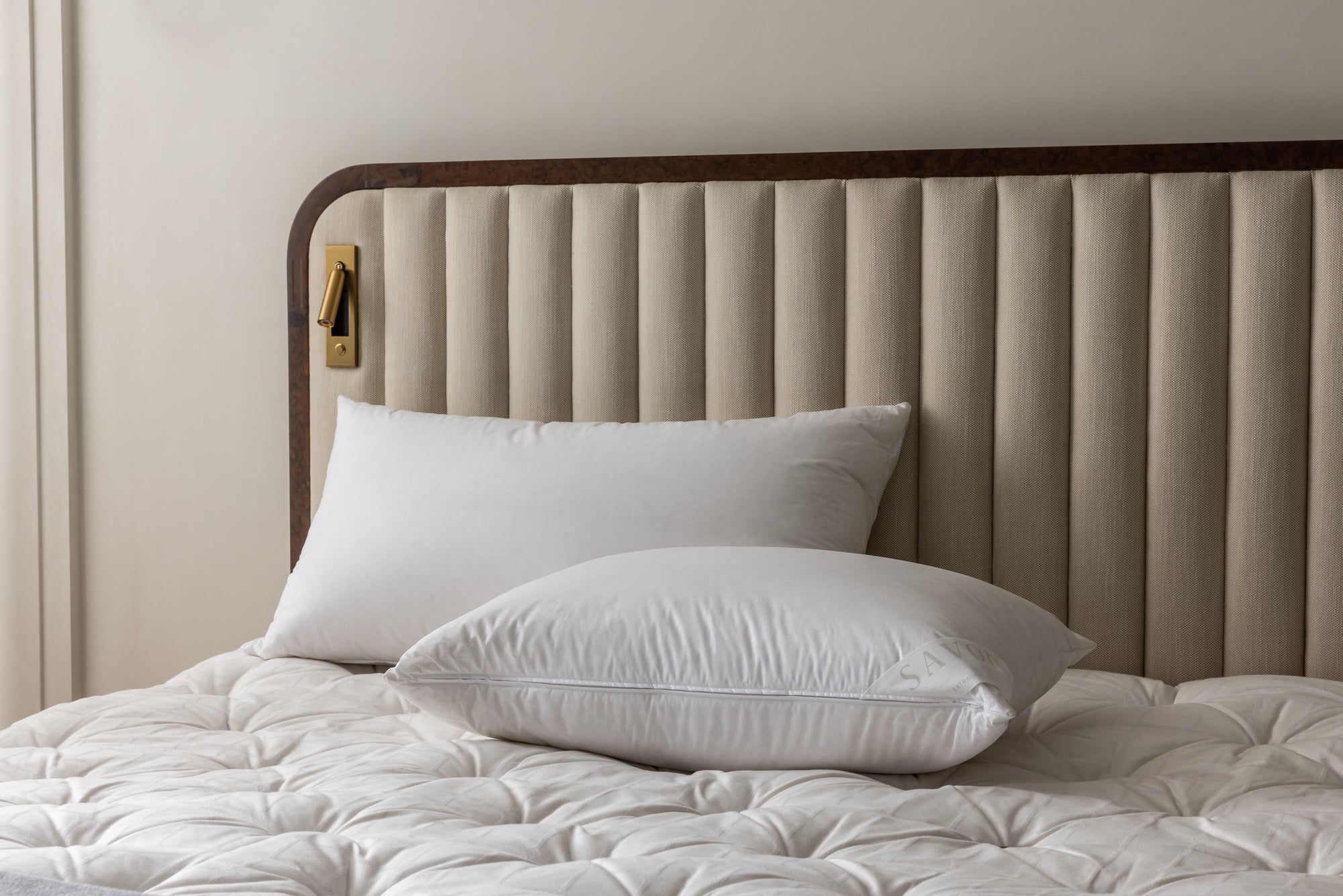 two multi-tension masuric goose down pillows on savoir luna bed