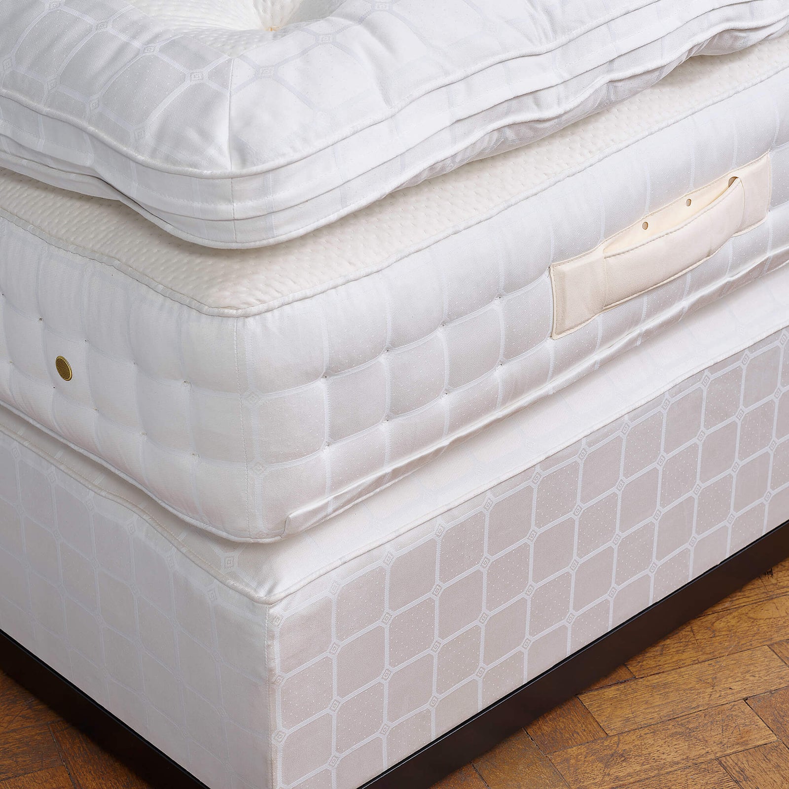 Savoir bed set no1 with a close up of the mattress, the topper and the base.