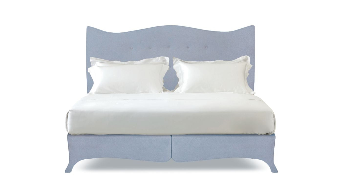 Undressed Penelope bed with a sky blue headboard and base featuring a mattress and cushions