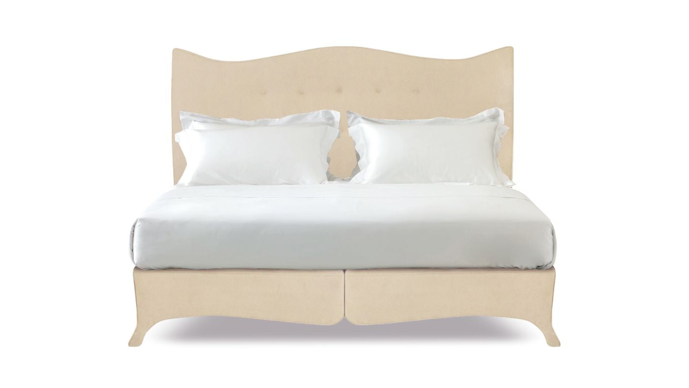 Undressed Penelope bed with a cream headboard and base featuring a mattress and cushions