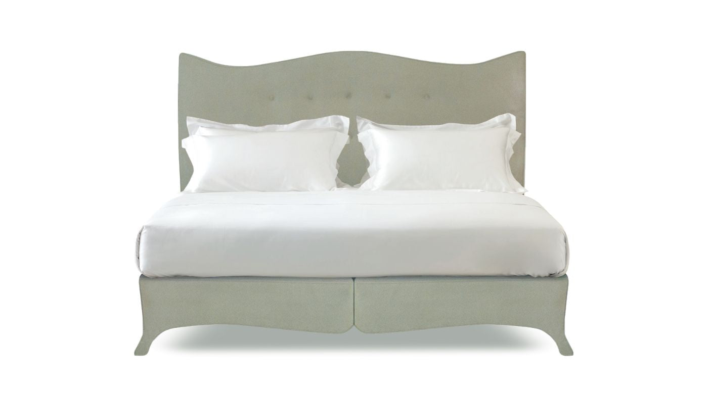 Undressed Penelope bed with a lime green headboard and base featuring a mattress and cushions