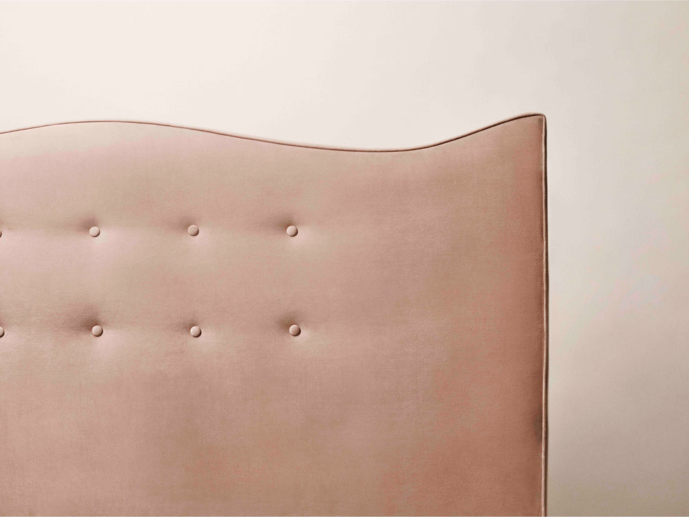 A close-up of the buttoning on the Penelope peach headboard