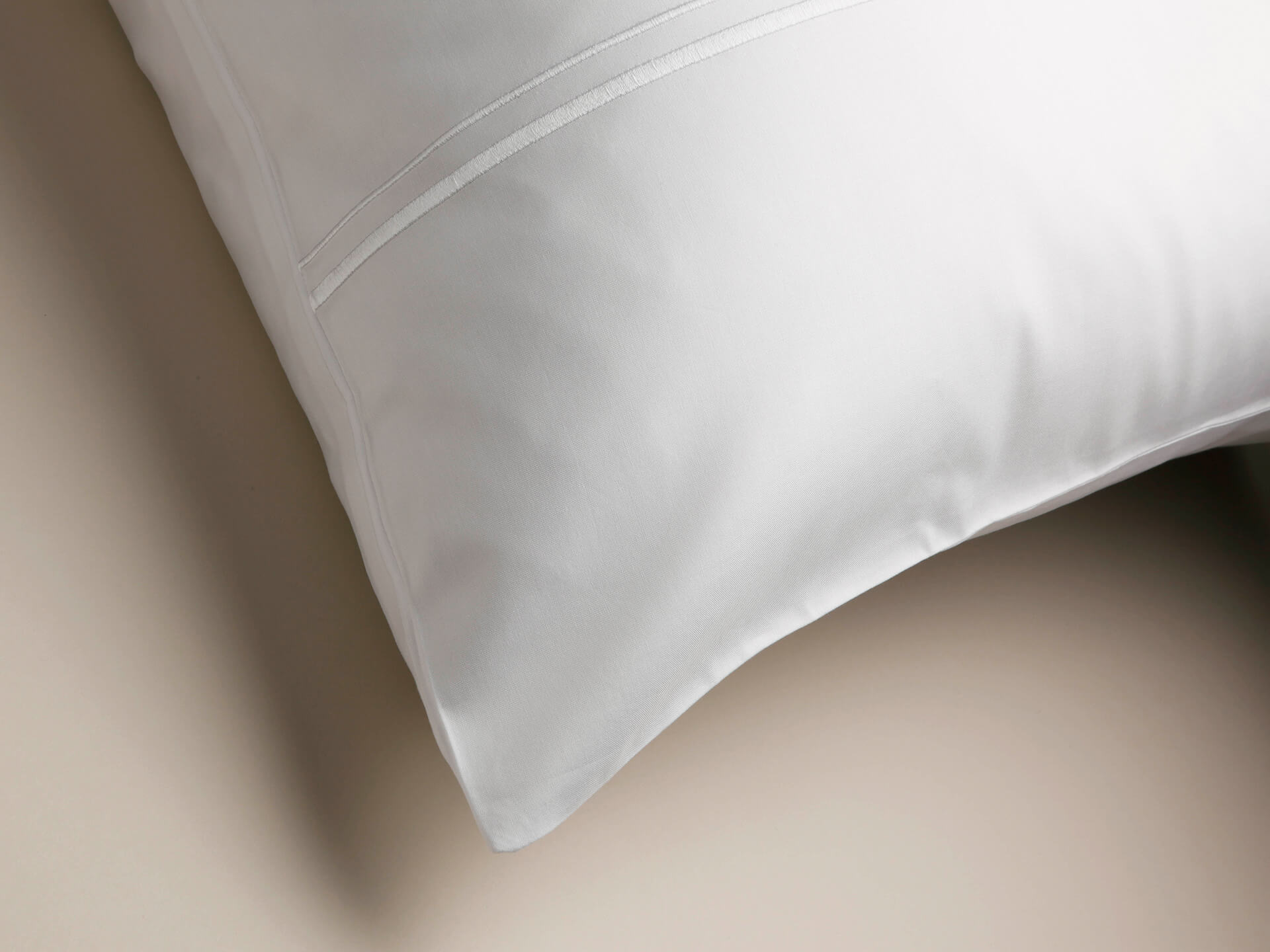 Corner of a pillowcase with white cording