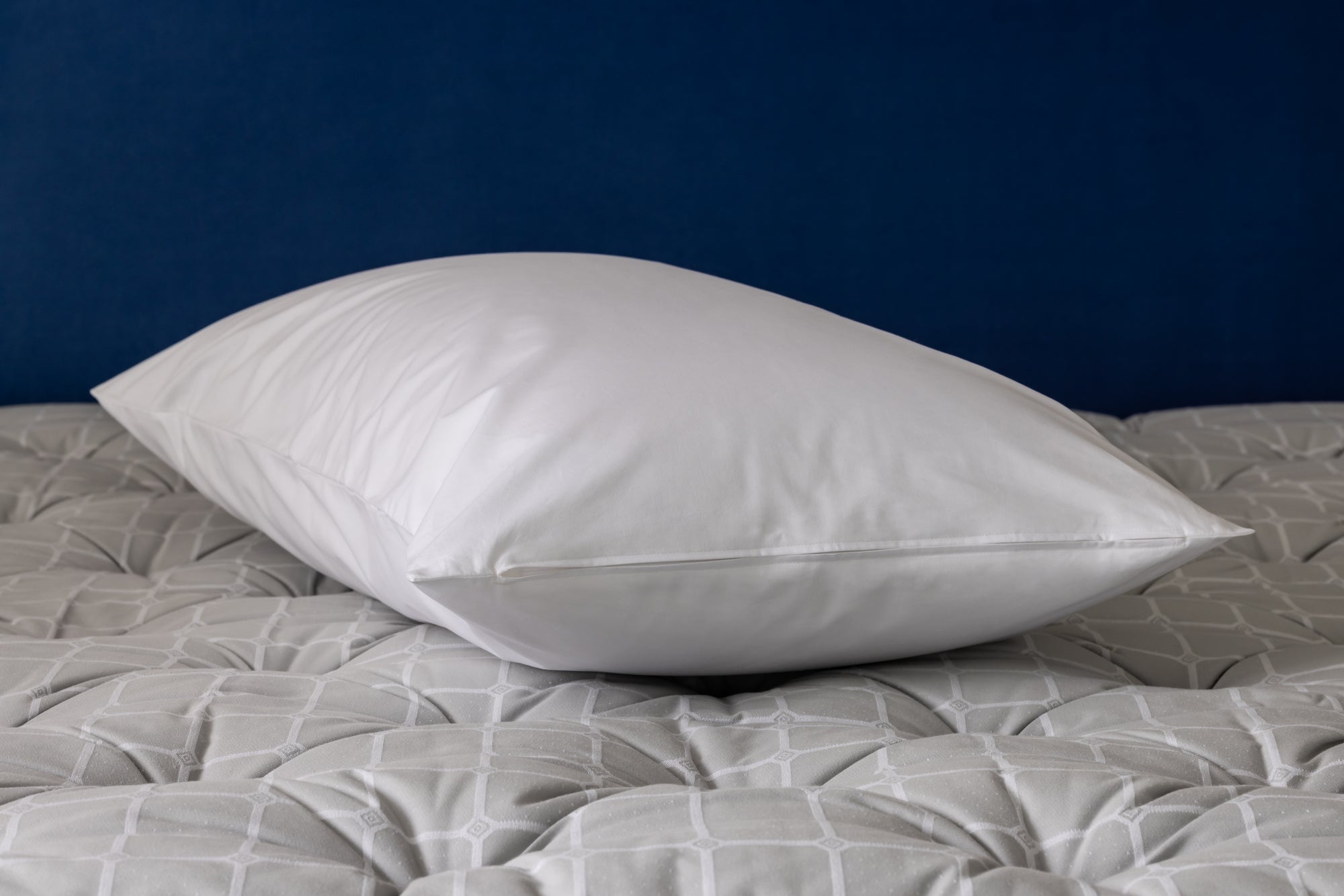white pillow inside pillow protector on a savoir mattress