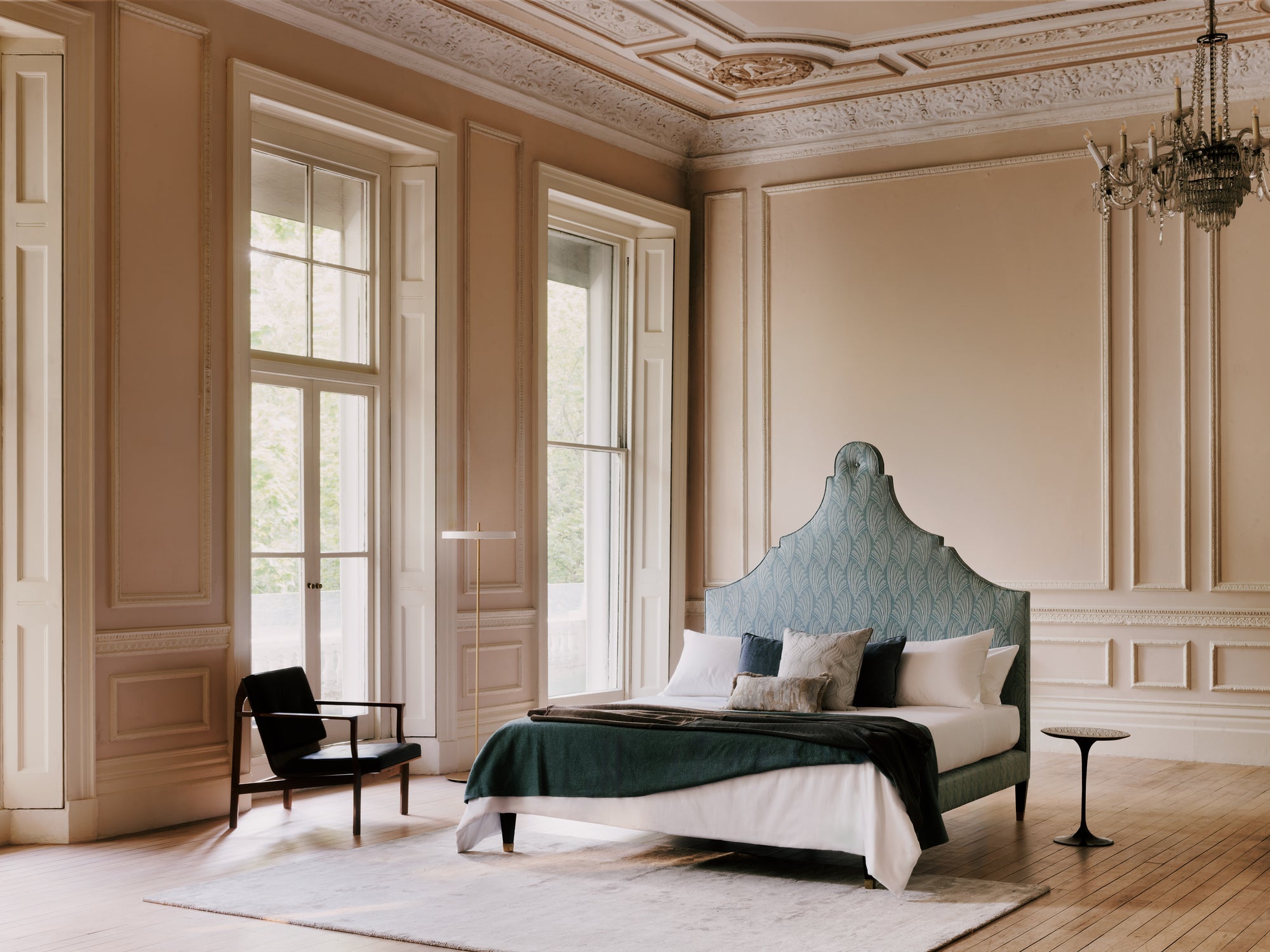 The Claudia bed with headboard with green pattern in a room with wooden floor