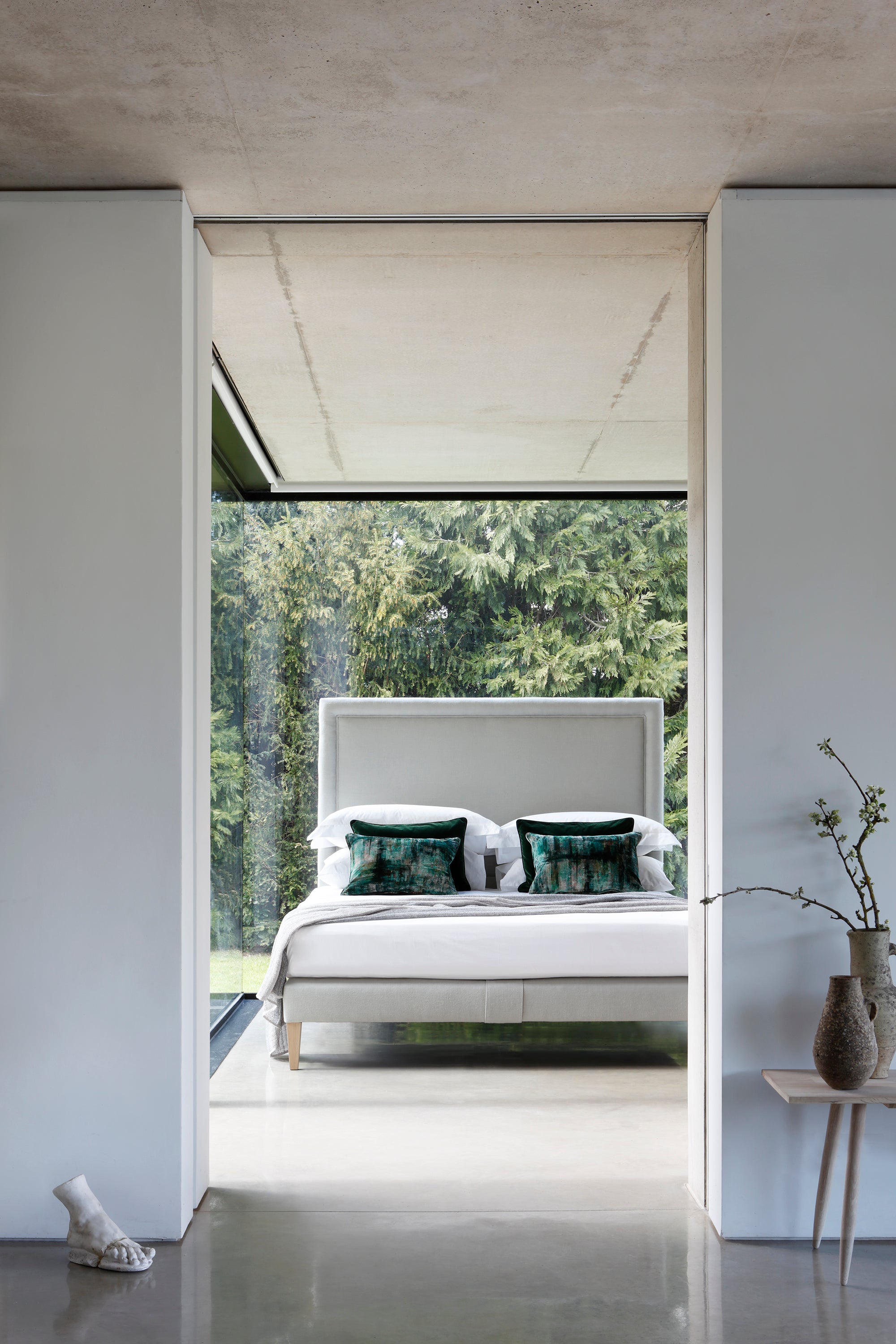 The Reformer bed with headboard and base upholstered in linen.