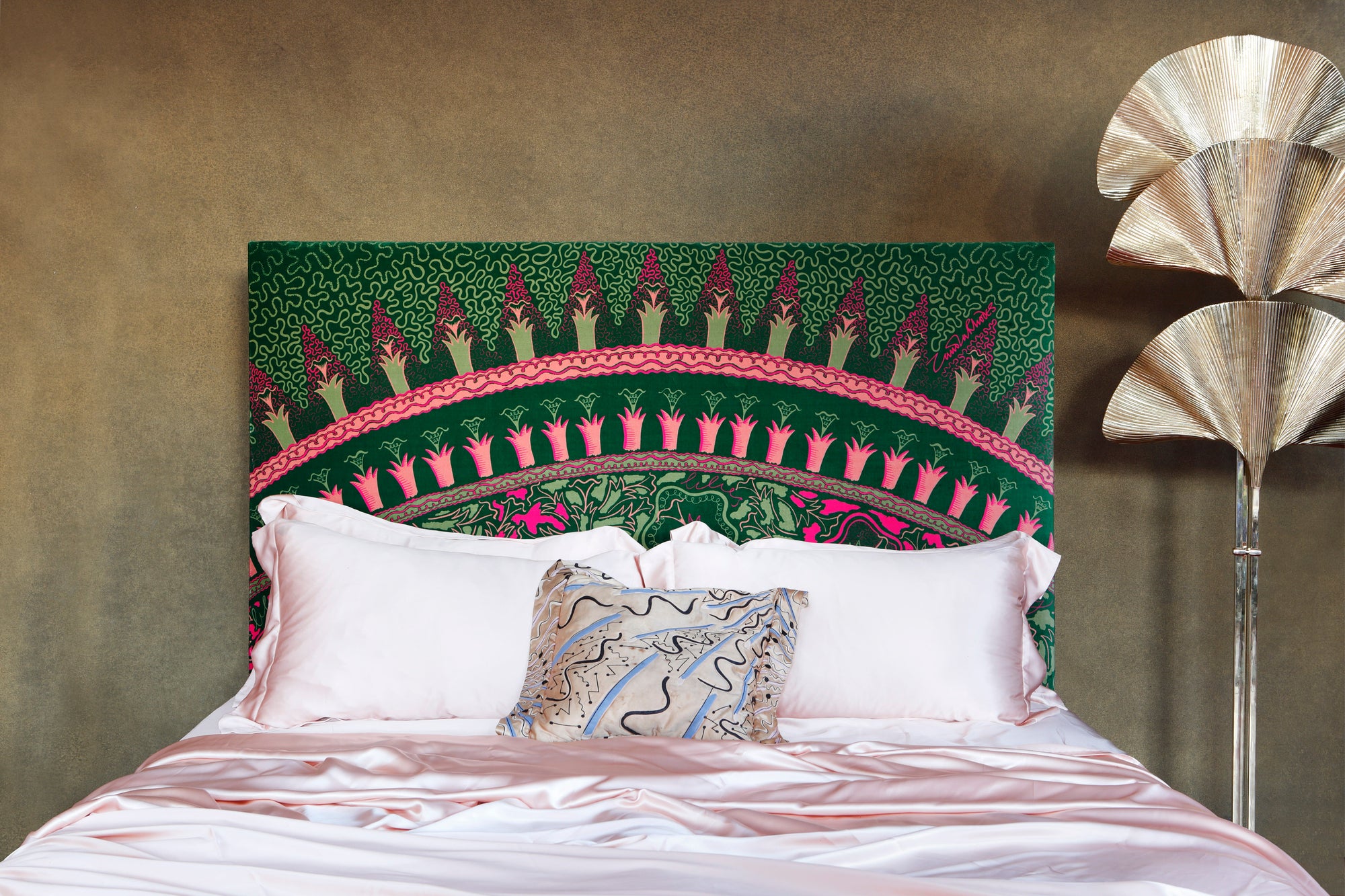 Zandra Rhodes bed with a colourful headboard