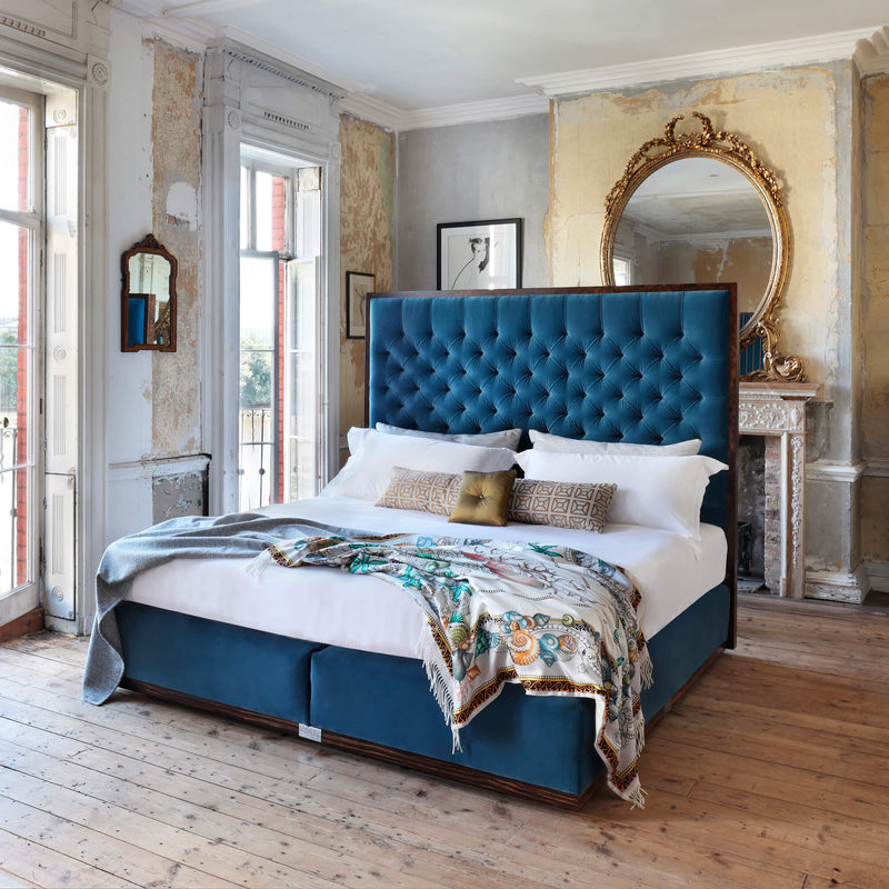 Savoir State bed with blue headboard and base completely dressed and set in a room