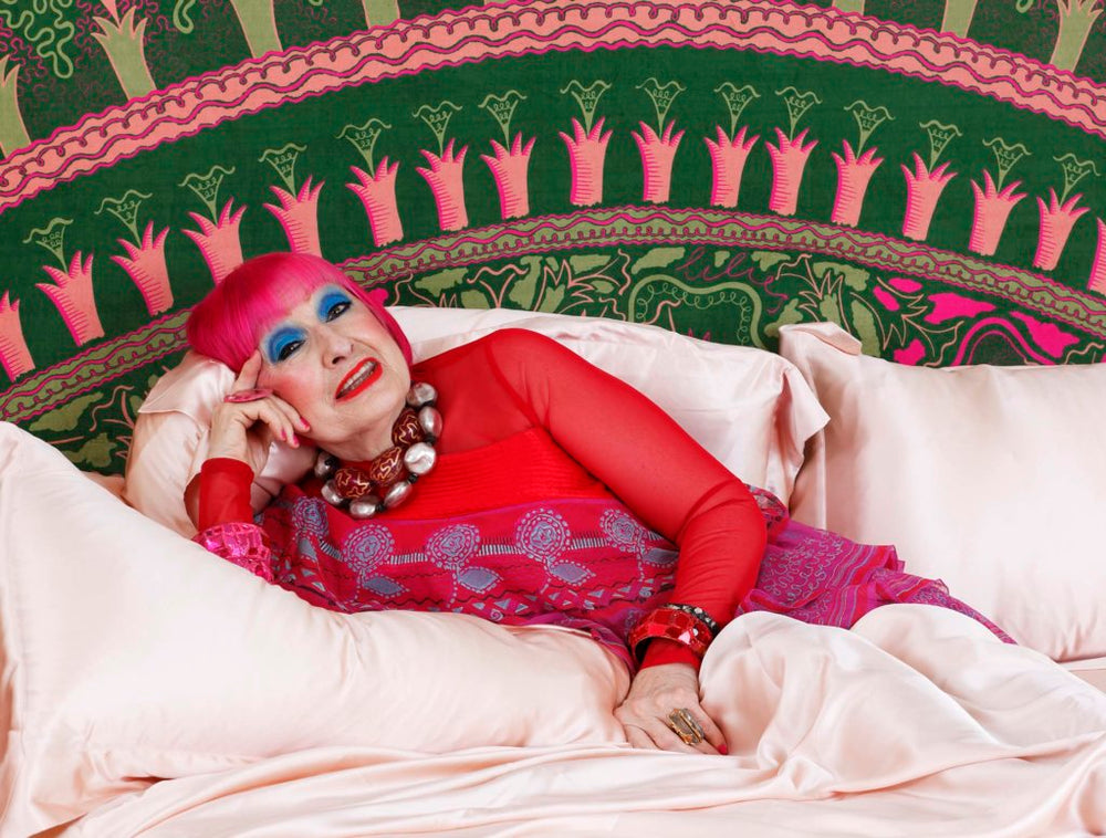 Designer Zandra Rhodes laying on the Lilies bed