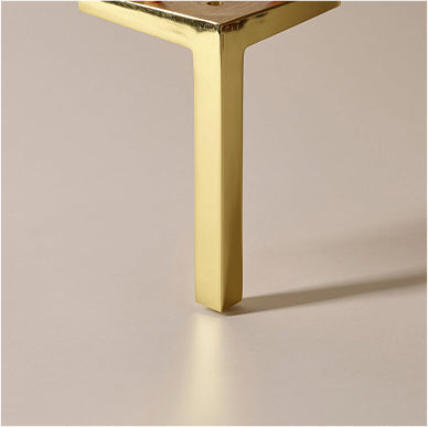 Close-up detail of the gold metal finish leg