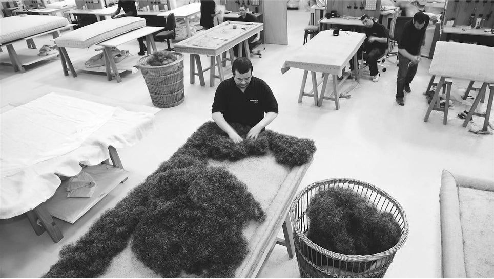 Entire view of the Savoir London bedworks with craftsmen at work