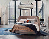 Angled view of the Three Sixty bed fully dressed in a bright room